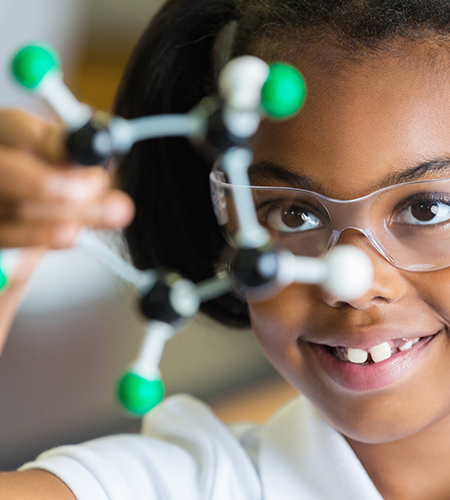 Bambina che sperimenta nel laboratorio di scienze.​