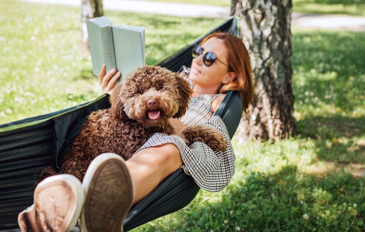 Woman,Reading,Book,Relaxing,In,Hammock
