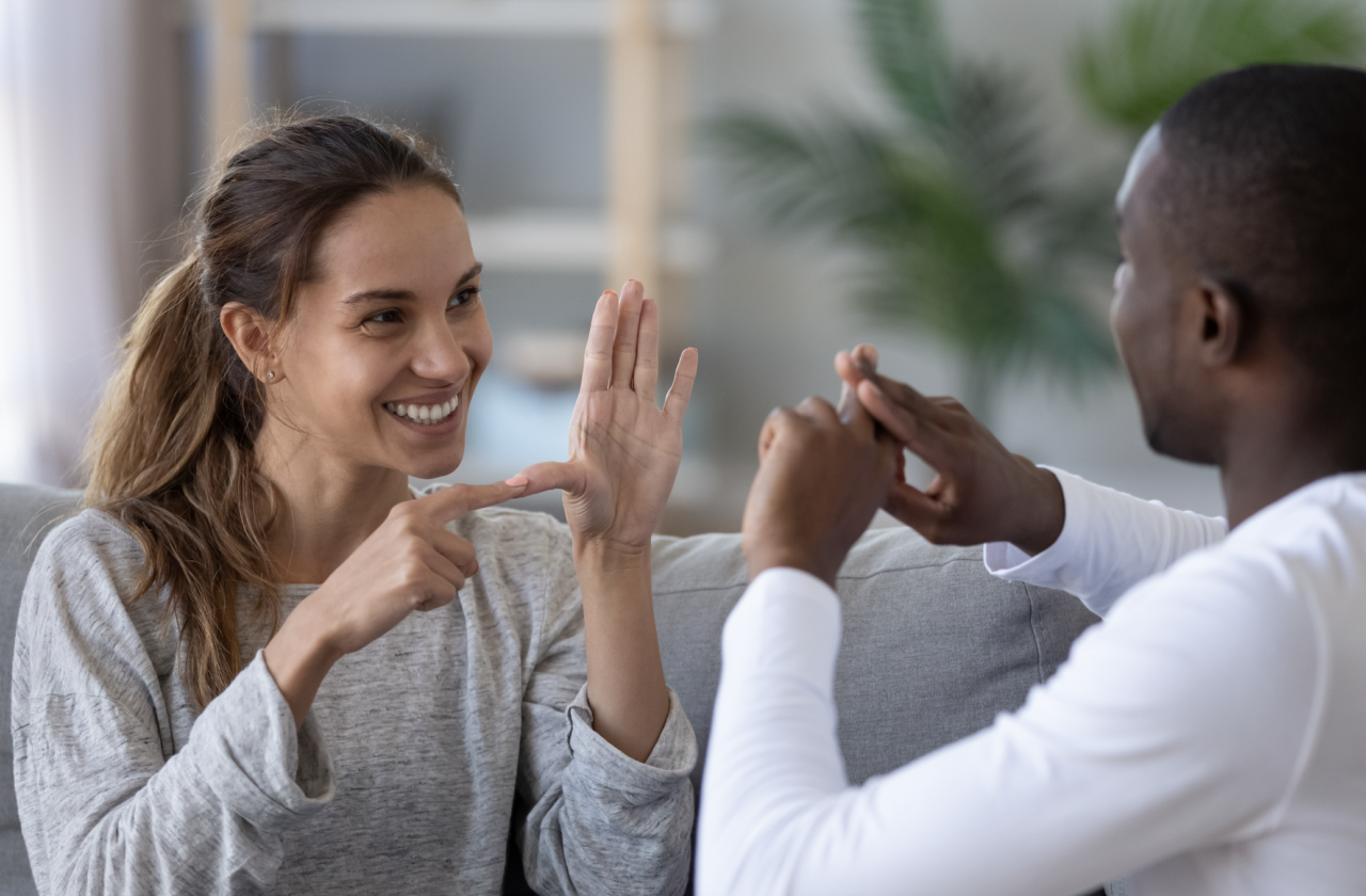 A man and a woman using sign language